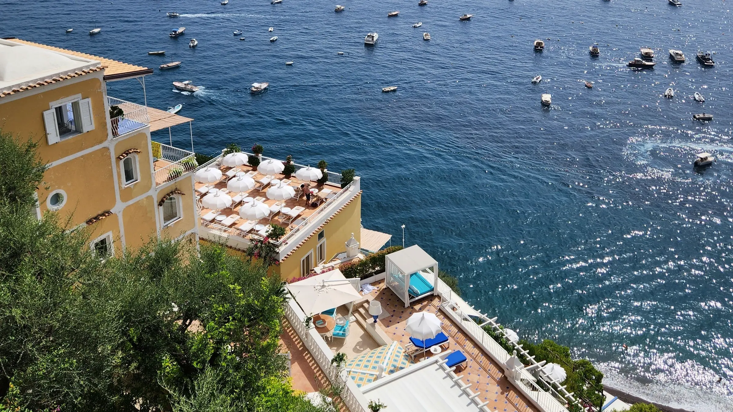 Yellow hotel on the cliff above the sea in Positano